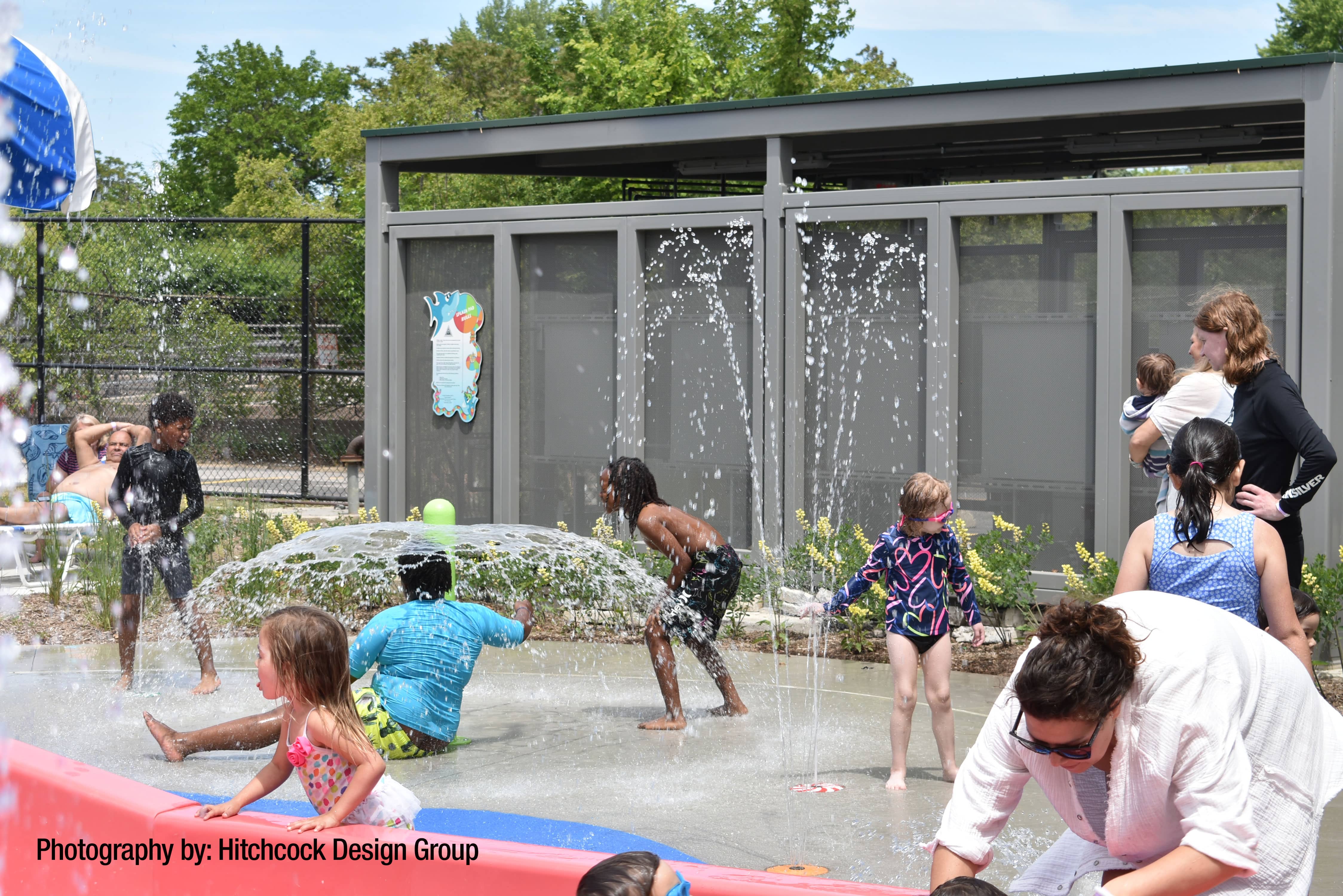 children interacting with aquatic play products at a spray park